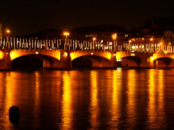 Bridges on the Rhine in Basel. Mittlere Rheinbrücke by night with Christmas illumination
